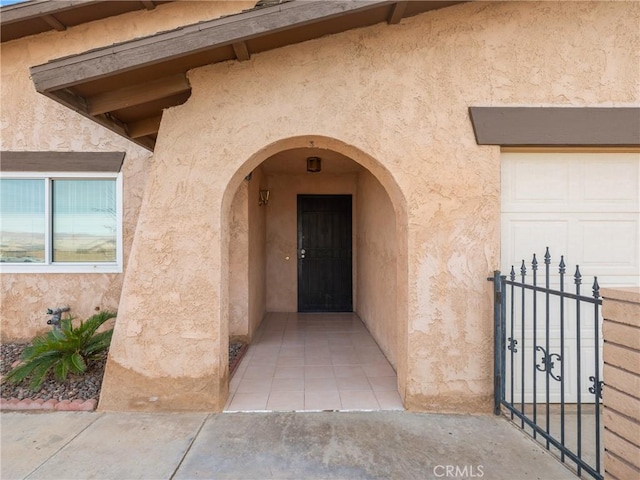 doorway to property with a garage