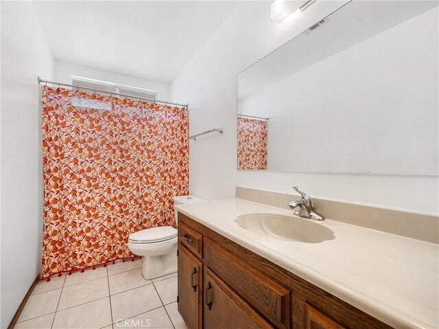 bathroom featuring toilet, vanity, and tile patterned flooring