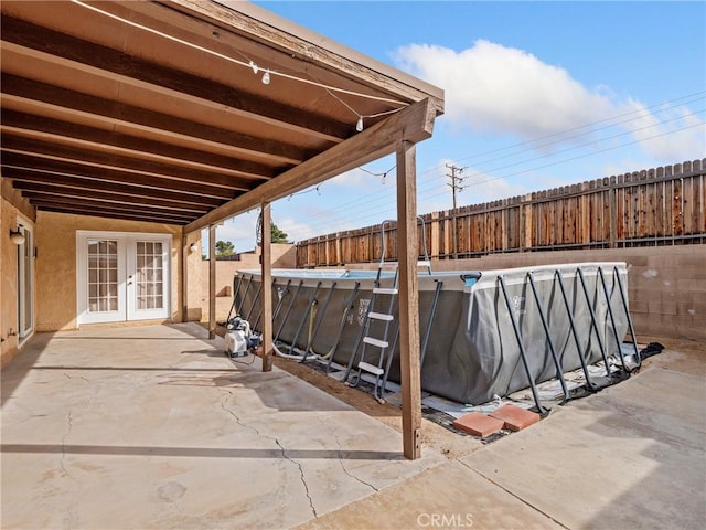 view of patio featuring french doors and a fenced in pool