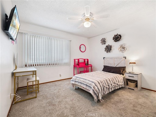 carpeted bedroom with ceiling fan and a textured ceiling