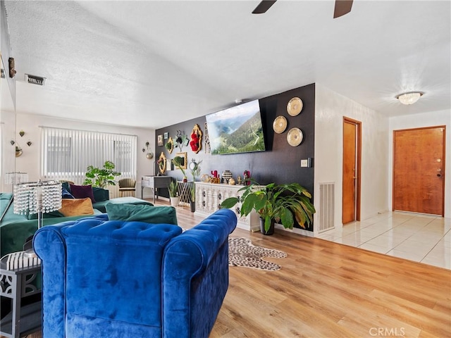 living room featuring hardwood / wood-style flooring and ceiling fan