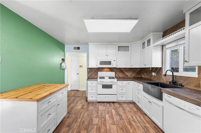 kitchen featuring white appliances, white cabinetry, and sink