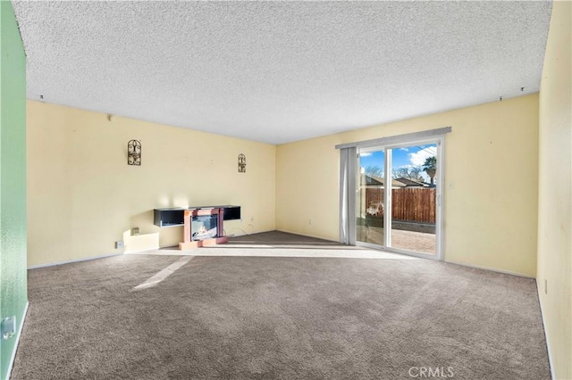 unfurnished living room with carpet flooring and a textured ceiling