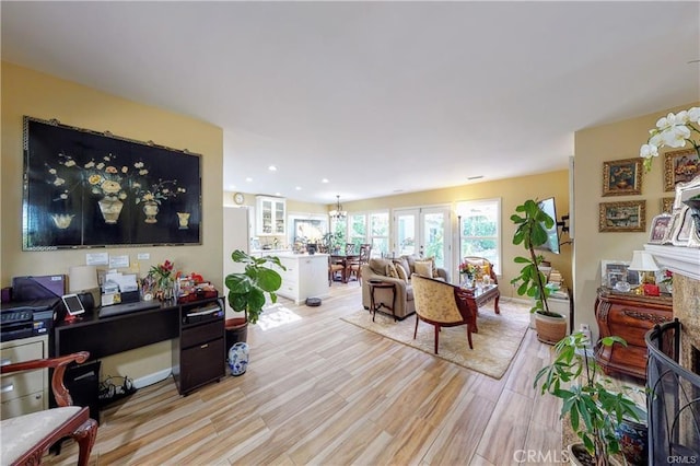 living room with french doors and light hardwood / wood-style flooring