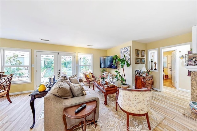 living room featuring light wood-type flooring and french doors