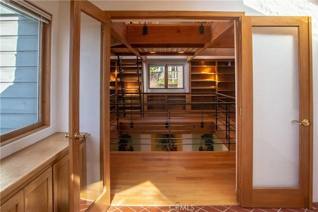 wine room featuring beamed ceiling