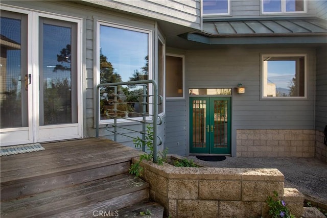 property entrance featuring metal roof, french doors, and a standing seam roof