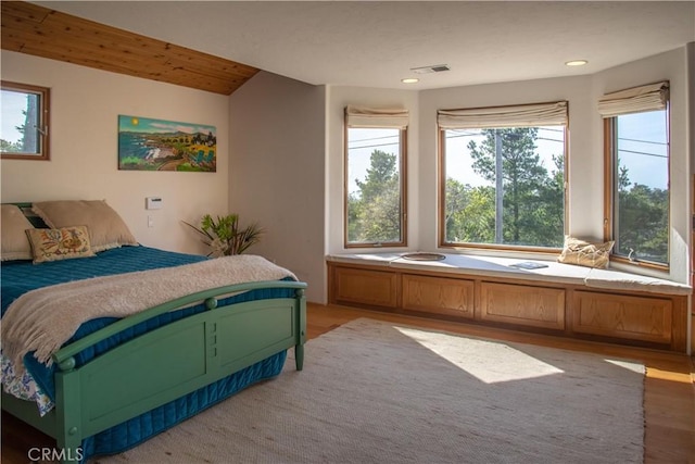 bedroom with recessed lighting, visible vents, and wood finished floors