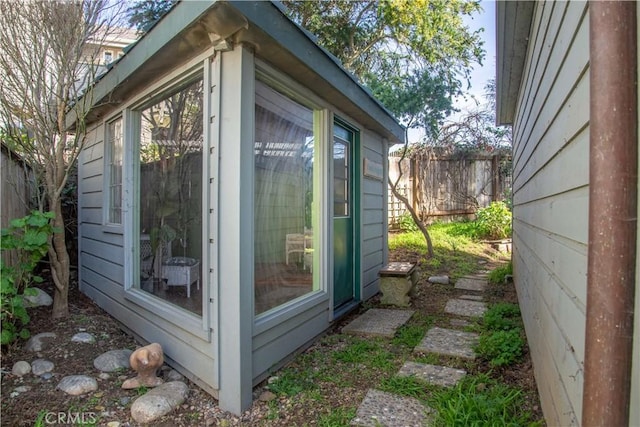 view of outbuilding featuring an outbuilding and fence