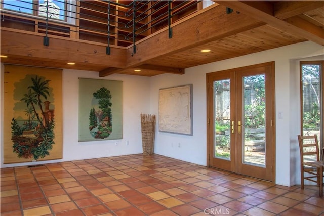 interior space with recessed lighting, a high ceiling, visible vents, french doors, and beam ceiling