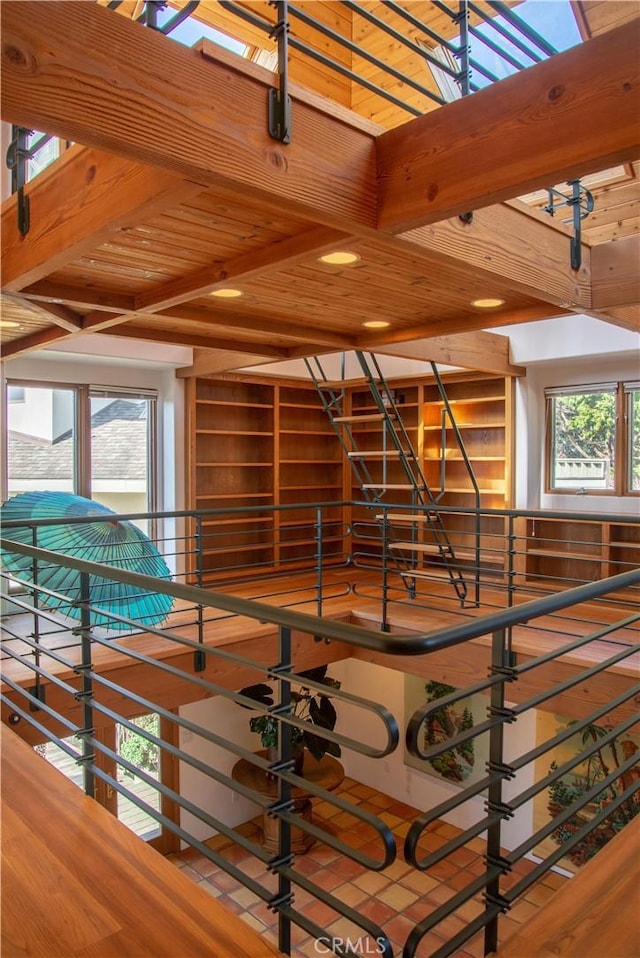 interior space featuring wooden ceiling, beam ceiling, and wood finished floors