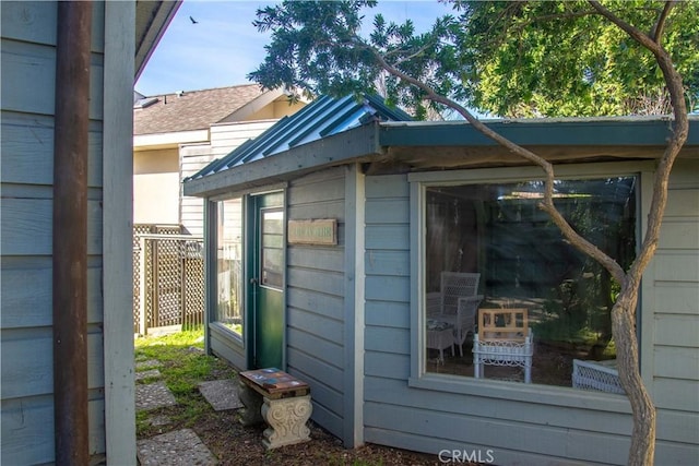 view of home's exterior featuring metal roof and an outdoor structure