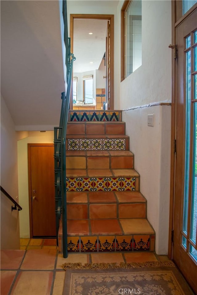 stairway featuring tile patterned flooring