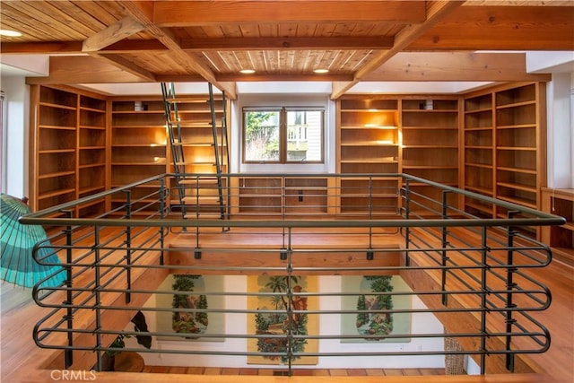 interior space featuring beamed ceiling, wood finished floors, and wood ceiling