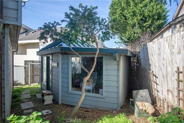 view of outbuilding featuring an outbuilding and fence