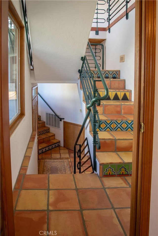 staircase featuring visible vents