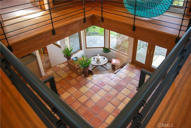 unfurnished living room featuring tile patterned flooring and french doors