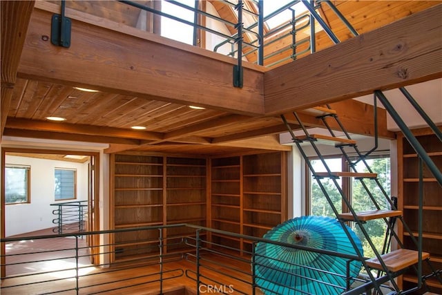 interior space featuring beam ceiling, a skylight, and wood ceiling