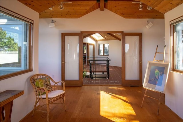 doorway to outside with wooden ceiling and lofted ceiling with beams