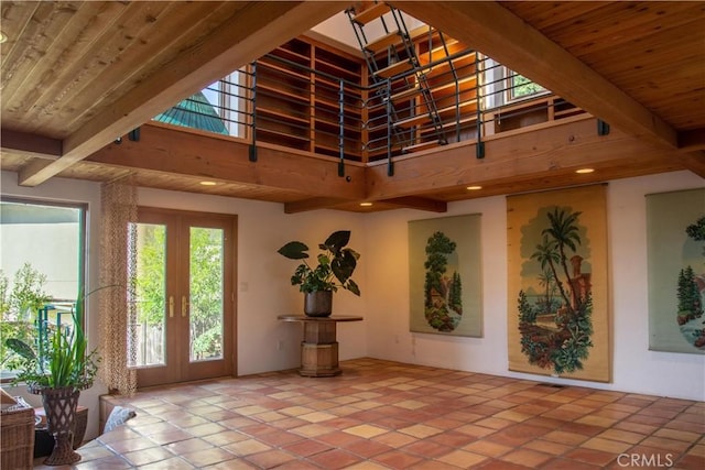 interior space featuring french doors, wooden ceiling, and beam ceiling