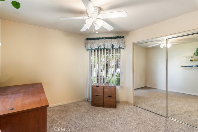 unfurnished bedroom featuring a ceiling fan and a closet