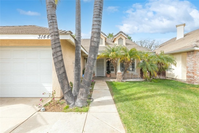 exterior space with a garage, a front lawn, and stucco siding