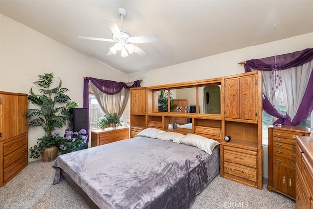 bedroom featuring vaulted ceiling, ceiling fan, and light colored carpet