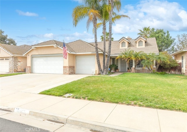 view of front of home featuring brick siding, stucco siding, an attached garage, driveway, and a front lawn