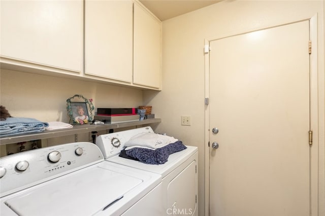 laundry area with cabinet space and washer and clothes dryer