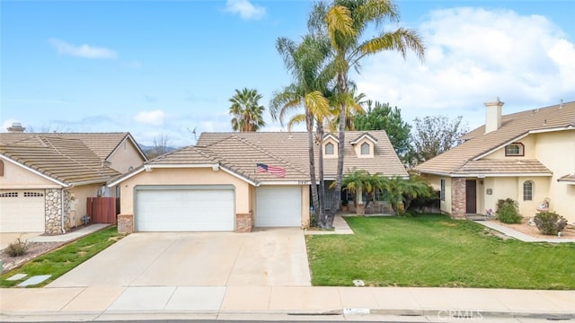 view of front of home featuring brick siding, stucco siding, concrete driveway, an attached garage, and a front lawn