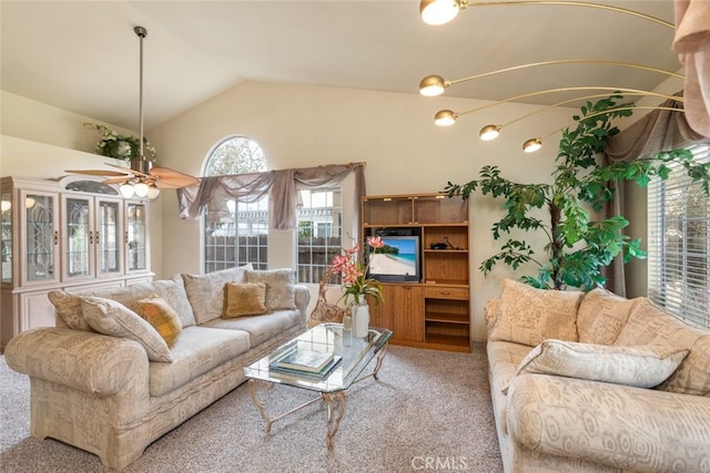 carpeted living area with vaulted ceiling and a ceiling fan