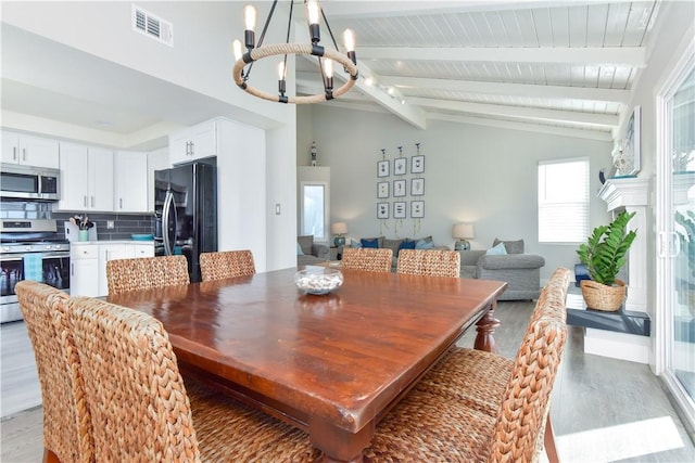 16791 Bayview Dr, Huntington Beach, CA 92649 - dining space with a chandelier, light wood finished floors, and wood ceiling