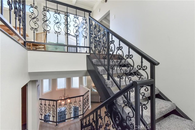 16791 Bayview Dr, Huntington Beach, CA 92649 - stairs with a chandelier and a high ceiling