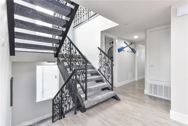 16791 Bayview Dr, Huntington Beach, CA 92649 - stairway with baseboards, wood finished floors, and recessed lighting