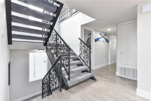 16791 Bayview Dr, Huntington Beach, CA 92649 - stairs with wood finished floors and recessed lighting