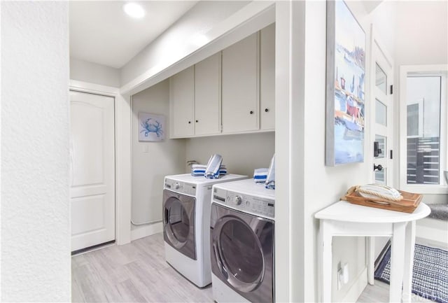 16791 Bayview Dr, Huntington Beach, CA 92649 - laundry area with washer and dryer, cabinet space, and light wood-type flooring