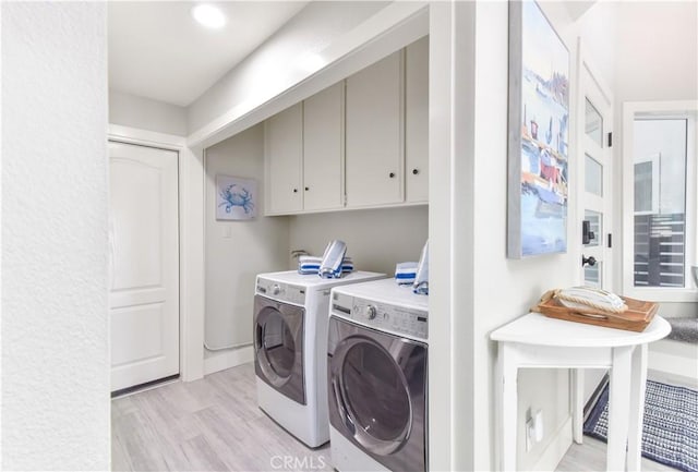 16791 Bayview Dr, Huntington Beach, CA 92649 - laundry room with washing machine and clothes dryer, cabinet space, and light wood-style flooring