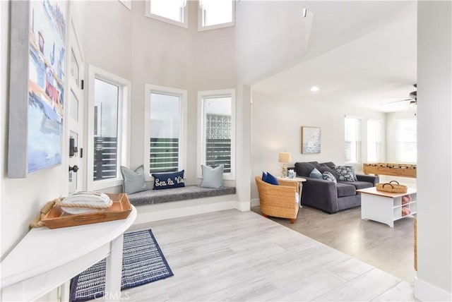16791 Bayview Dr, Huntington Beach, CA 92649 - living area featuring wood finished floors, a ceiling fan, and a high ceiling