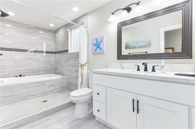 16791 Bayview Dr, Huntington Beach, CA 92649 - bathroom featuring tiled shower, toilet, vanity, tiled tub, and recessed lighting