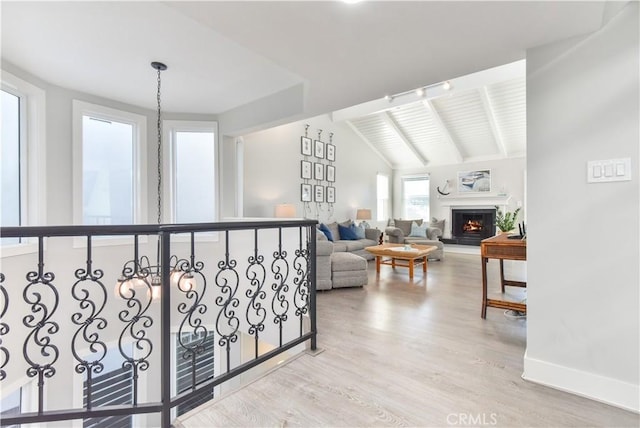 16791 Bayview Dr, Huntington Beach, CA 92649 - living room featuring light wood-type flooring, a lit fireplace, and baseboards