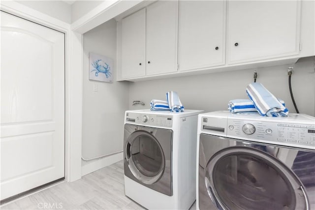 16791 Bayview Dr, Huntington Beach, CA 92649 - washroom with cabinet space, washer and dryer, and baseboards