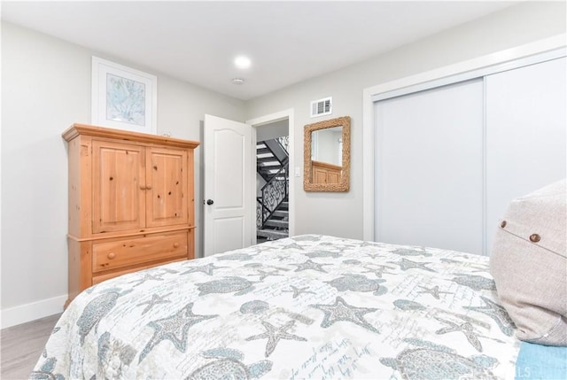 16791 Bayview Dr, Huntington Beach, CA 92649 - bedroom featuring wood finished floors, a closet, and baseboards