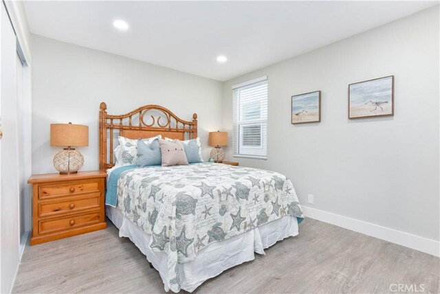 16791 Bayview Dr, Huntington Beach, CA 92649 - bedroom with light wood-style flooring, baseboards, recessed lighting, and a closet