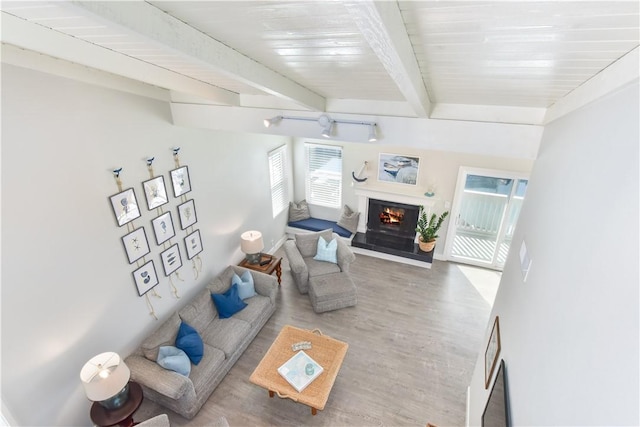 16791 Bayview Dr, Huntington Beach, CA 92649 - living room with wood finished floors, a lit fireplace, beamed ceiling, and baseboards