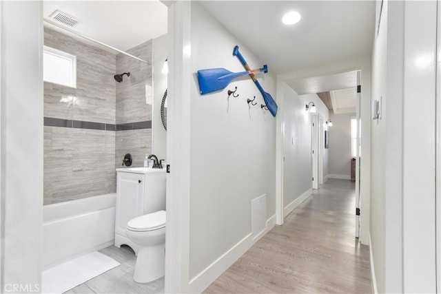 16791 Bayview Dr, Huntington Beach, CA 92649 - bathroom with toilet, wood finished floors, shower / bath combination, and baseboards