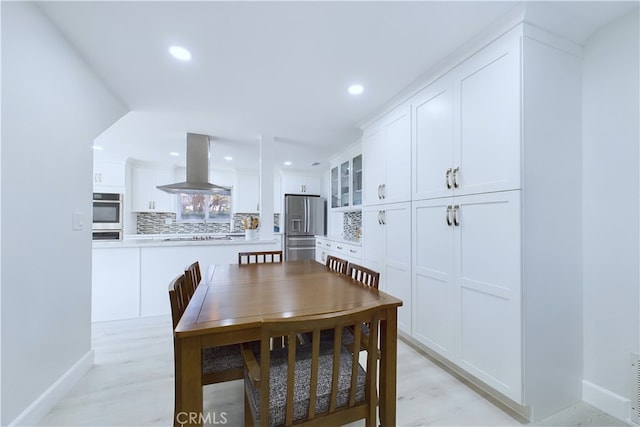 dining space with light hardwood / wood-style floors