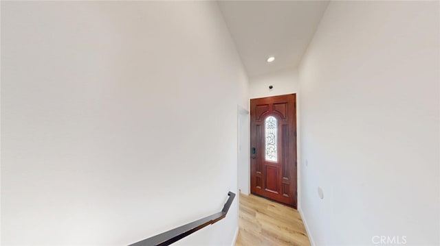 doorway featuring light wood-type flooring, baseboards, and recessed lighting