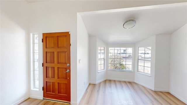 entrance foyer featuring light wood-style flooring and baseboards