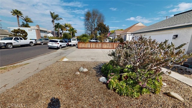 view of street with sidewalks, a residential view, and curbs