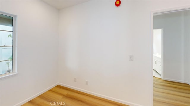 unfurnished room featuring baseboards and wood finished floors